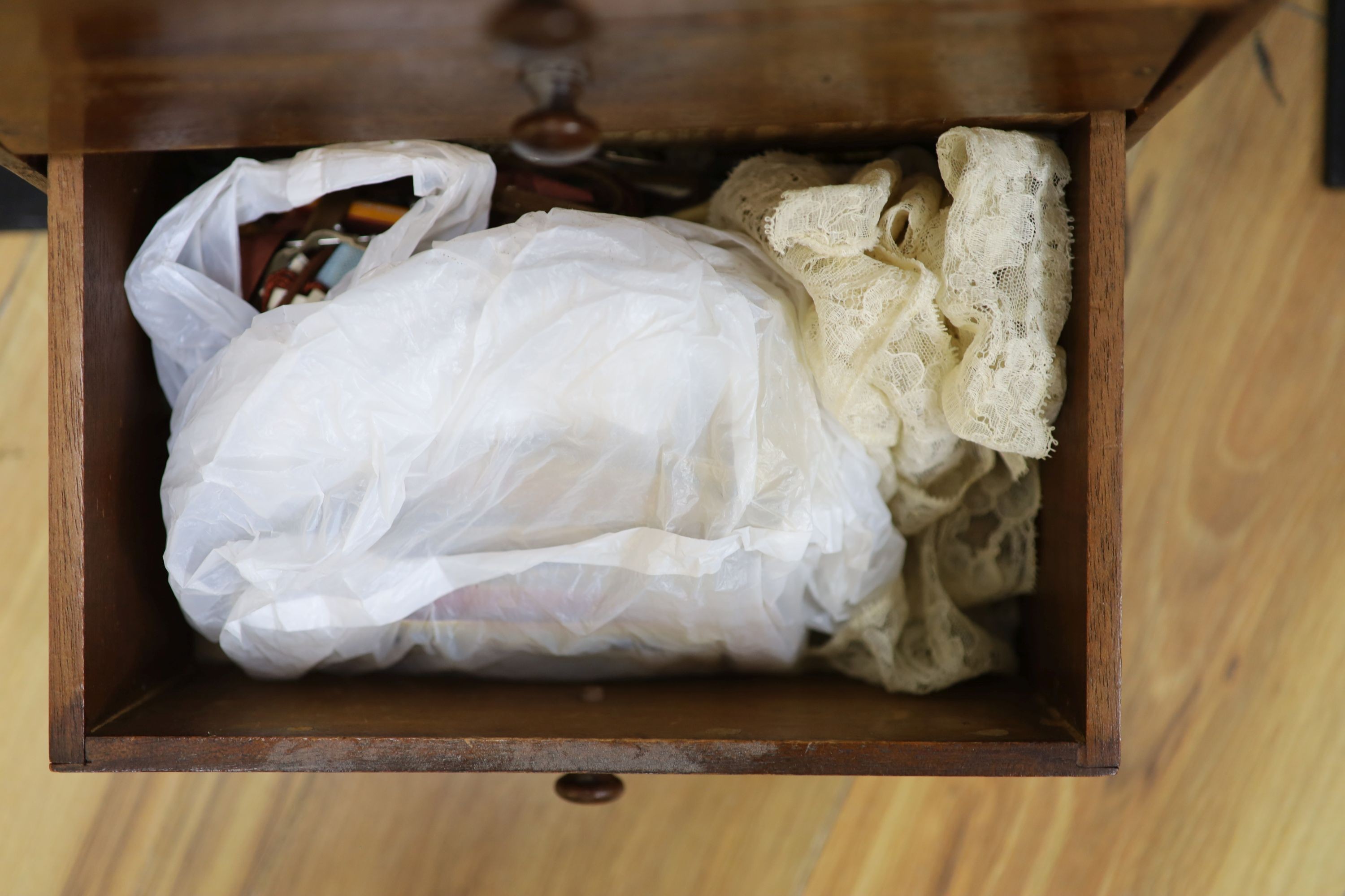 An early 20th century miniature chest and contents
